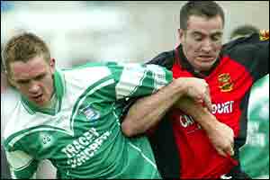 Fermanagh midfielder Martin McGrath arm and arm with Sean Ward