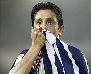 Real Sociedad's Nihat kisses his shirt after scoring a goal against Atletico de Madrid