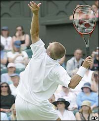 Hewitt serves to opponent Ivo Karlovic