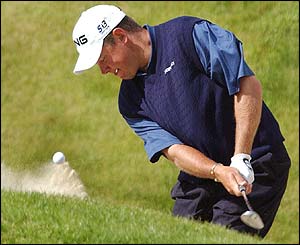 Lee Westwood plays out of a bunker