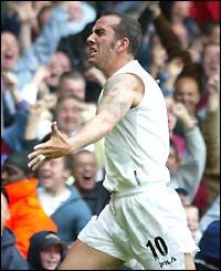Paolo Di Canio takes his shirt off after scoring