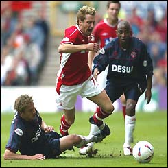 Darren Huckerby skips past two defenders