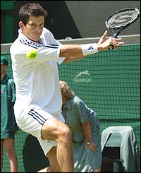 Tim Henman plays a backhand against Tomas Zib