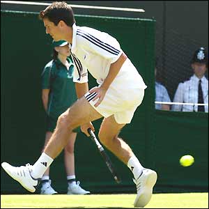 Tim Henman returns the ball between his legs