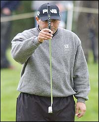 Defending champion Angel Cabrera lines up a putt