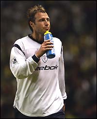 A delighted-looking Paul Warhurst walks off the pitch after Bolton's 1-0 win at Old Trafford