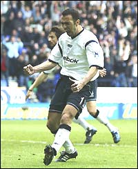 Djorkaeff celebrates his strike at the Reebok