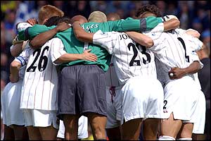 West Ham players form a huddle before the match