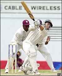 Austyralia's Justin Langer clubs the ball to the boundary