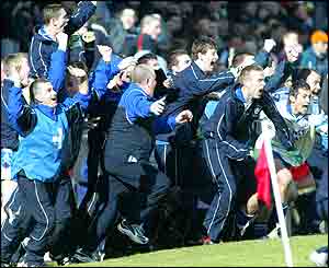 The Monaghan bench arises to celebrate victory over Armagh