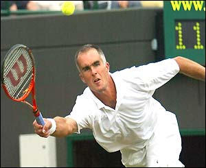 Todd Martin stretches to play a forehand