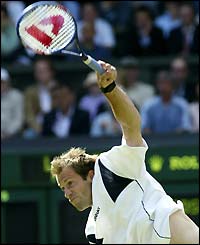 Greg Rusedski thunders down a serve during his match with Andy Roddick