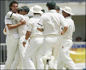 Australia's Jason Gillespie celebrates taking the wicket of Devon Smith