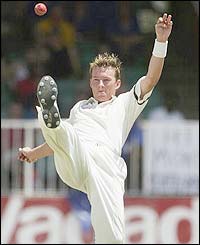 Australia bowler Brett Lee kicks the ball away
