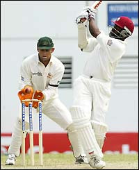 Brian Lara is bowled by Stuart MacGill