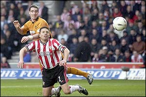 Wolverhampton Wanderers player Mark Kennedy heads the ball as Southampton's Jason Dodd challenges him