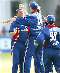Darren Gough is mobbed by his England team-mates after he gets Doug Marillier out