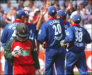 Tatenda Taibu leaves the crease as England celebrate in the background