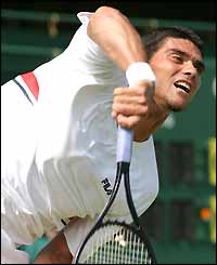 Big-serving Australian Mark Philippoussis gets the better of Cyril Saulnier 