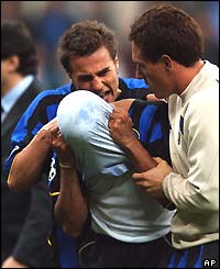 Ivan Cordoba (centre) hides his head in his shirt after Inter are eliminated from the Champions League