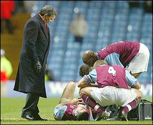 Graham Taylor looks over as Mark Delaney lies injured during a game with Blackburn