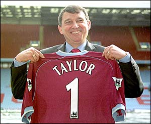 Graham Taylor holds aloft a Aston Villa shirt after taking over as manager for a second time