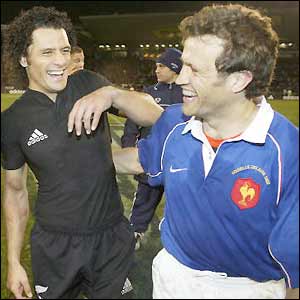 New Zealand's Doug Howlett shares a joke with France captain Fabien Galthie