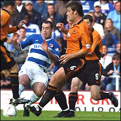 Reading's Andy Hughes is thwarted by Wolves defenders