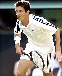 Tim Henman follows a forehand into the net
