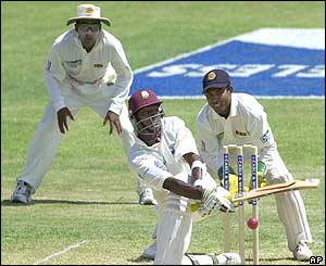 West Indies batsman Vasbert Drakes plays a sweep shot