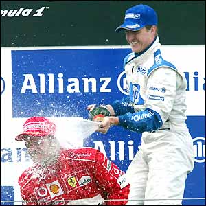 Ralf Schumacher celebrates his win on the podium
