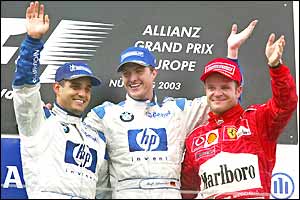Juan Pablo Montoya, Ralf Schumacher and Rubens Barrichello pose on the podium