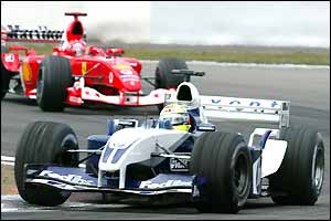 Ralf Schumacher leads Michael Schumacher after Kimi Raikkonen's enforced retirement