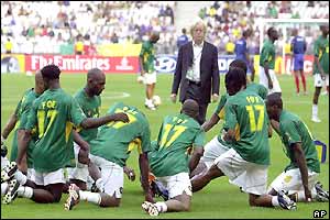 The Cameroon team warm-up wearing Foe shirts before the final