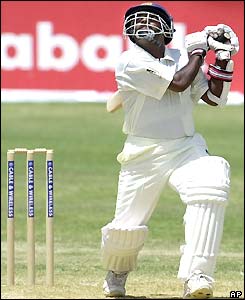 Muttiah Muralitharan skies a shot off Corey Collymore's bowling
