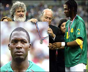 Sepp Blatter hangs a runner-up medal on the picture of Marc-Vivien Foe