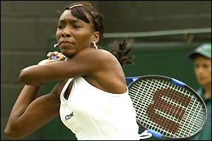 Venus Williams frowns as she returns the ball to Vera Zvonareva
