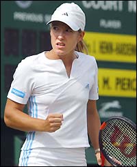 Justine Henin-Hardenne clenches her fist in delight after winning a point against Mary Pierce