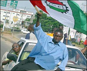 An NLC official waving the union flag in Lagos