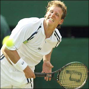 David Nalbandian strains as he hits a serve