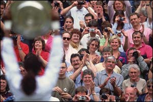 Venus Williams holds the trophy aloft in front of an adoring Centre Court crowd