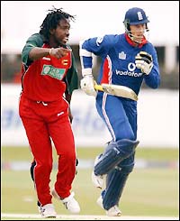 Marcus Trescothick runs past Zimbabwes Douglas Hondo but manages only three runs