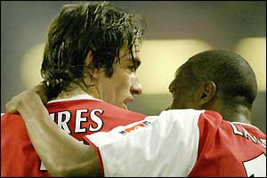Arsenal's Robert Pires is congratulated by team-mate Lauren