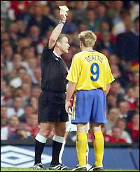 Southampton's James Beattie is booked by referee Graham Barber