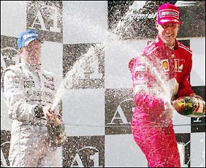 McLaren's Kimi Raikkonen celebrates on the podium after holding on for second place