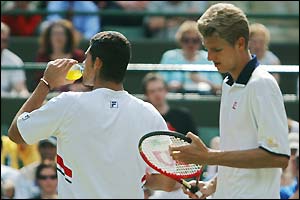 Mark Philippoussis and Alexander Popp take a break on Court One