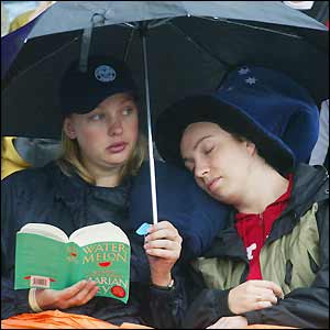 Fans patiently await the resumption of play on Court One