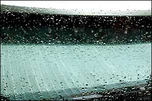 Rain falls on the covers protecting Court One