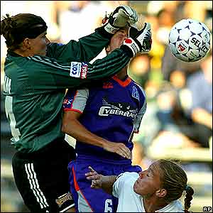 San Diego Spirit goalkeeper Jenni Branam, left, punches the ball away from San Jose CyberRay's Brandi Chastain