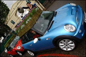James Newman, 25, of Leeds, waters the roof garden on his Mini Cooper S car at the Chelsea Flower Show